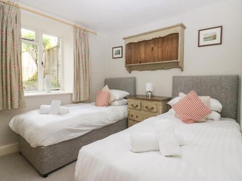 a bedroom with two beds and a window at River Lodge in Ambleside