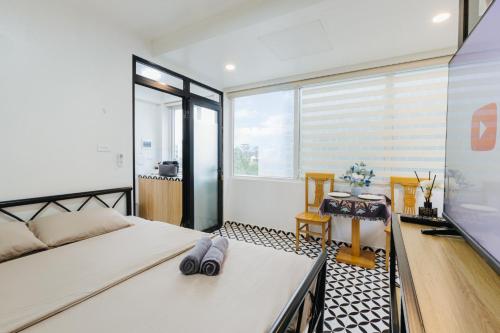 a bedroom with a bed and a large window at COSY HOUSE - CENTER'S TAY HO - CLOSE THE LAKE in Hanoi