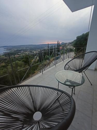 a balcony with two chairs and a table and a view at Newly Renovated Endless view Dimitra's House in Vlachata