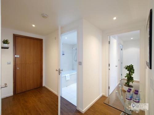 a bathroom with a shower and a glass door at Deluxe Two Bed Apartment by London ExCeL & O2 in London