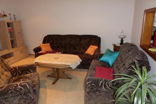 a living room with a couch and a table at Wunderschönes Ferienhaus in Altwarp mit Grill in Altwarp