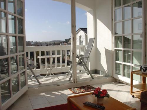 a room with a balcony with a chair and a table at Ferienwohnung mit Balkon und Tiefgarage in Ostseebad Sellin