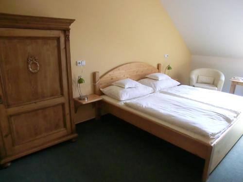 a bedroom with a bed with white sheets and pillows at Pension Rondel in Poděbrady