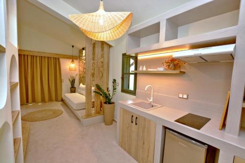 a bathroom with a sink and a mirror at Villa Emilia Suites in Pachis