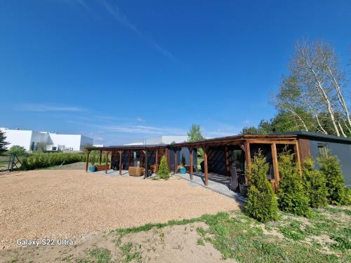 a building with a greenhouse with trees in it at Domki303 in Mszczonów