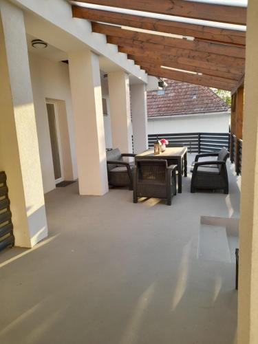 a patio with chairs and a table on a building at Villa Anna, ingyenes Wifivel és parkolással. in Zalaegerszeg