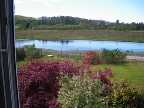 a view of a lake from a window at Rowanhill Cottage in Acharacle