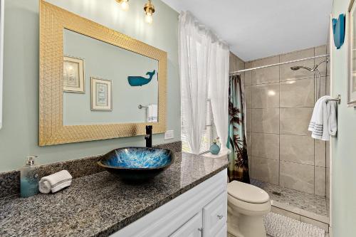 a bathroom with a sink and a toilet at Casa Maria 1- Beachy Apt Mins Walk to Downtown in Saint Augustine