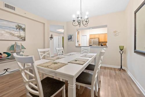 a kitchen and dining room with a white table and chairs at Seaside Escape - Spacious 3 Bedroom Ground Floor Condo - Steps to Atlantic Ocean in St. Augustine
