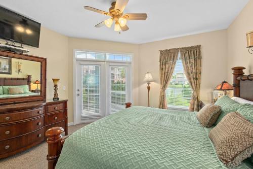 a bedroom with a bed and a ceiling fan at Seaside Escape - Spacious 3 Bedroom Ground Floor Condo - Steps to Atlantic Ocean in St. Augustine