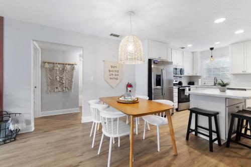 a kitchen and dining room with a table and chairs at Island Suite - Walk to Downtown! in St. Augustine