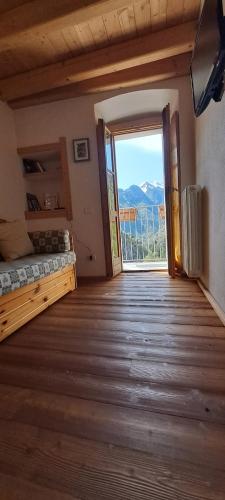 a room with a large sliding glass door with a view at ALBERGO DIFFUSO ORNICA NEL CUORE in Ornica