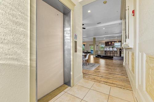 a hallway with a door leading to a waiting room at The Ray - Penthouse Suite - 360° Rooftop View in St. Augustine
