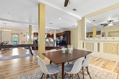 a dining room and living room with a table and chairs at The Ray - Penthouse Suite - 360° Rooftop View in St. Augustine