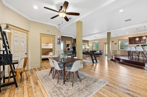 a dining room and living room with a ceiling fan at The Ray - Penthouse Suite - 360° Rooftop View in St. Augustine