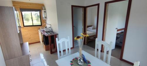 a room with a table with a vase on it at Cabañas en la naturaleza in Villarrica