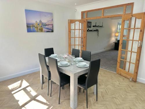 a dining room with a table and chairs at Long Term Comfort - Modern 3BR Retreat with Free Parking & WiFi in Enfield Lock