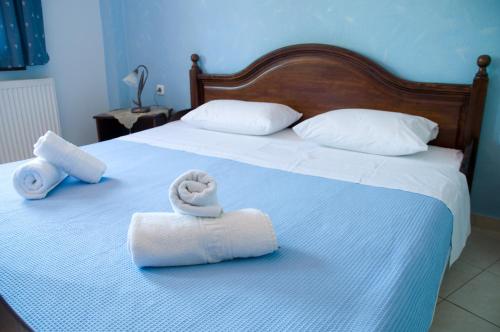 a bed with two towels and two pillows on it at Evridiki in Vergina