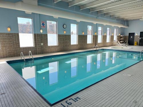a large swimming pool in a building at Divya Sutra Plaza and Conference Centre Calgary Airport in Calgary