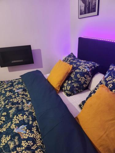 1 dormitorio con 1 cama y TV de pantalla plana en L'orchidée, en Verviers