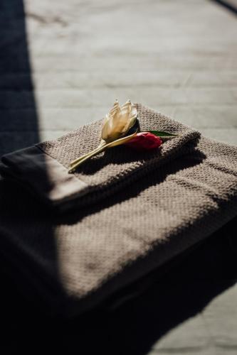 a table with a napkin with a rose on it at Kanoa Lodge - Adults and 18 plus only in Pavones