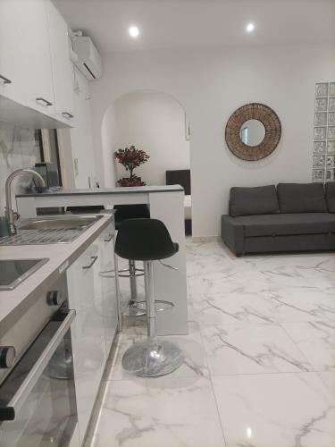 - une cuisine avec un tabouret au milieu d'une pièce dans l'établissement Appartement confortable a proximite de la mer., à Nice