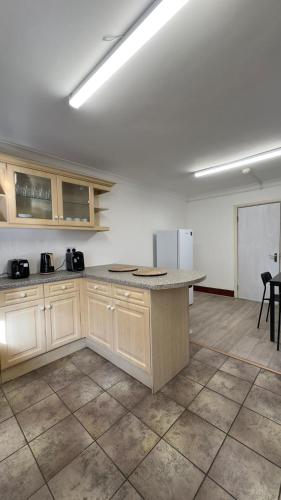 an empty kitchen with a counter in a room at 25 Minutes to Central London Rooms 35 in London