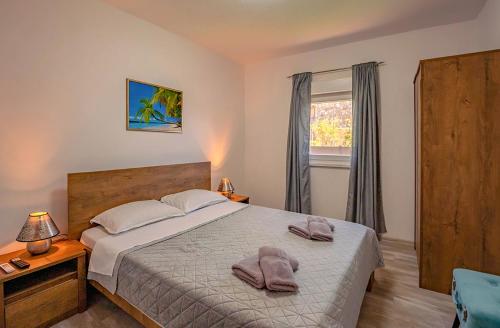 a bedroom with a bed with two towels on it at Koky in Juršići