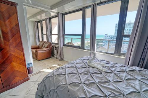 a bedroom with a bed and a view of the ocean at Oceanview Apartment on the beach 123 in Miami Beach