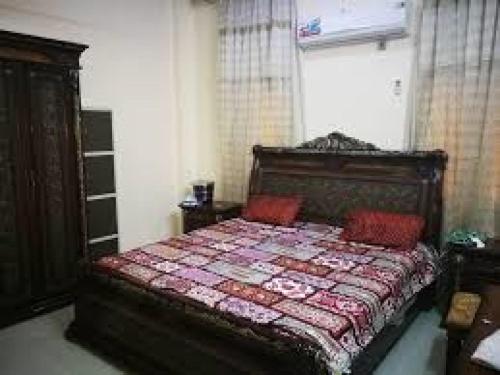 a bedroom with a bed with a quilt on it at Jordan road Guest House in Madaba
