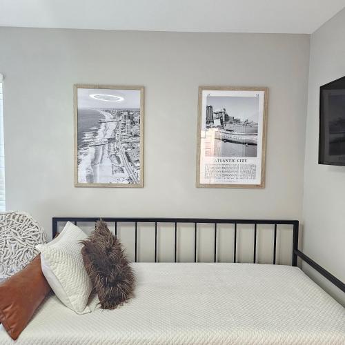 a bedroom with a bed with two pictures on the wall at Atlantic City Bungalow Retreat in Atlantic City