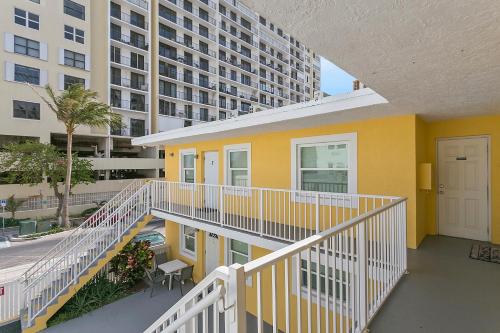 a yellow house with a balcony and a building at Blue Sky in Hollywood