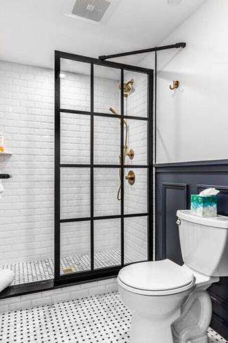 a bathroom with a white toilet and a shower at Canal View, DTWN Bangor, Steps to great Restaurants, Room # 210 in Bangor