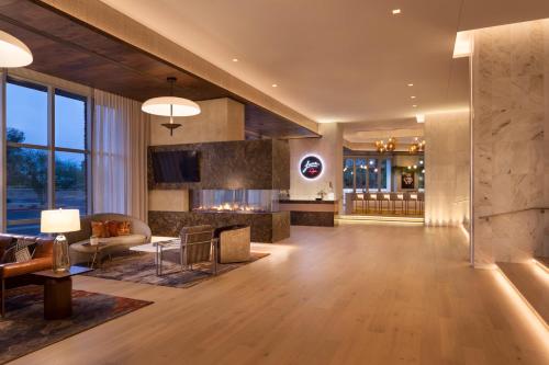 a living room with a couch and a fireplace at Caesars Republic Scottsdale, a Hilton Hotel in Scottsdale