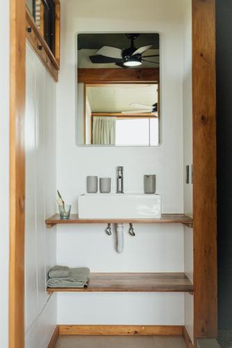 a bathroom with a sink and a mirror at Kanoa Lodge - Adults and 18 plus only in Pavones