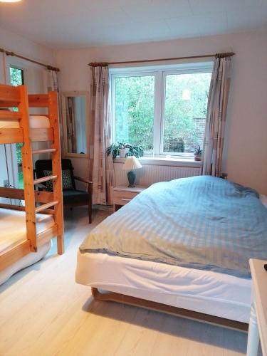 a bedroom with a bunk bed and a window at B&B Tvolm Ydby Thy in Tvolm