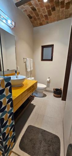 a bathroom with a sink and a toilet and a mirror at Real San Pedro. Hotel Boutique in San Pedro Tesistán