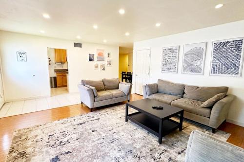 a living room with a couch and a coffee table at Large house and yard close to La Jolla, UCSD, UTC Mall! in San Diego