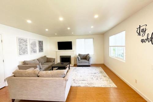 a living room with a couch and a tv at Large house and yard close to La Jolla, UCSD, UTC Mall! in San Diego