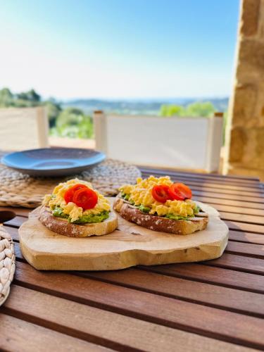 two sandwiches on a wooden cutting board on a table at B&B La Vista Brava in Platja  d'Aro