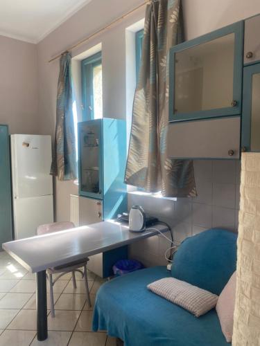 a room with a desk and a couch and a tv at Agroturystyka Oaza Ciszy i Spokoju in Międzychód