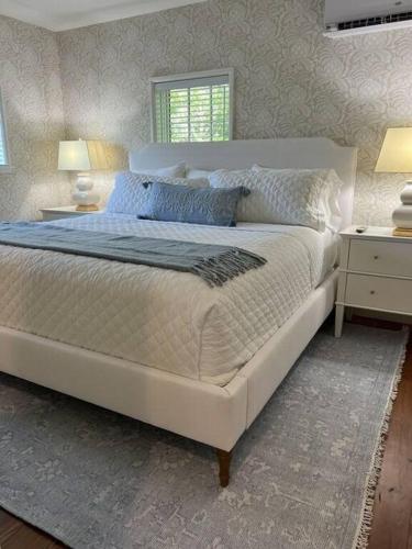 a bedroom with a large white bed with blue pillows at Upstairs at the Lake in Petoskey