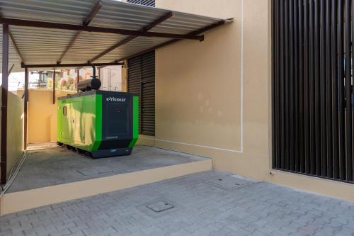 a green tv sitting under a cover on a building at VEERA RESIDENCY in Tiruvallūr