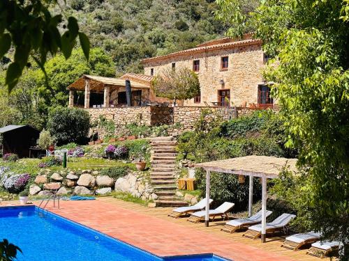 a house with a swimming pool in front of a house at B&B La Vista Brava in Platja  d'Aro