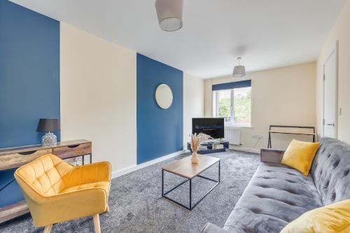 uma sala de estar com um sofá e uma mesa em 3 Bed House - Contractors, Relocators & Visitors, Coffee Machine & Free Parking em Bedford