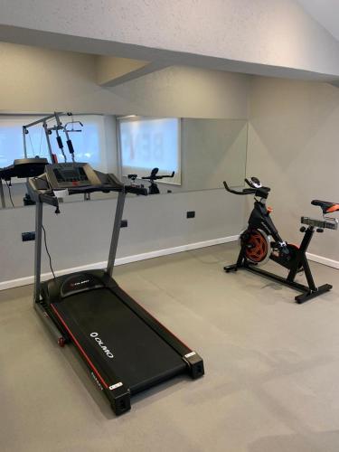 a room with a gym with a treadmill and a exercise bike at Benjamín I in San Salvador de Jujuy