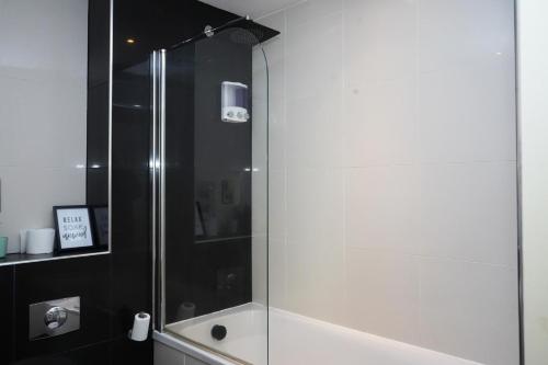 a shower with a glass door in a bathroom at Inviting 2-Bed Apartment in Sheffield in Sheffield