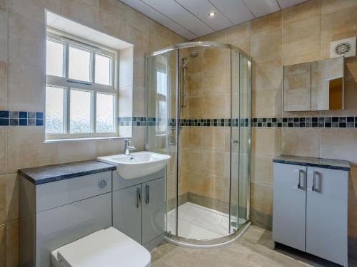 a bathroom with a shower and a toilet and a sink at 5 Bed in Bishop Auckland 83828 in Wolsingham