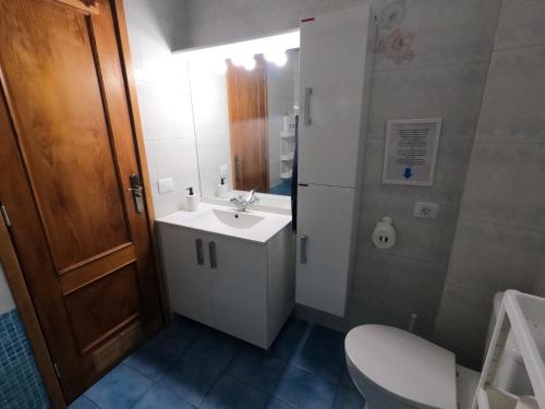 a bathroom with a white sink and a toilet at Big Room at Villa Lila in Puerto de la Cruz
