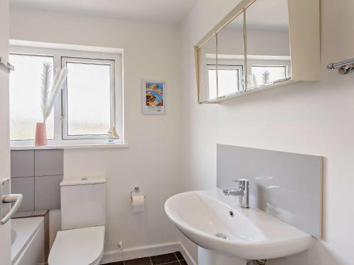 a white bathroom with a sink and a mirror at 2 Bed in Ilfracombe 82615 in Ilfracombe